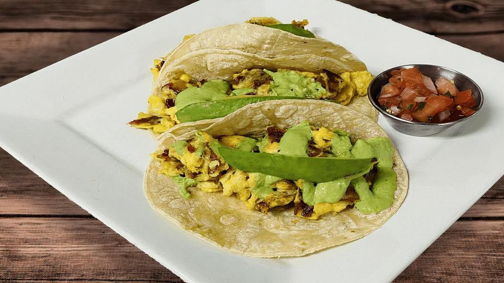 Breakfast Tacos · three corn tortillas filled with scrambled eggs with pinch of S&P, bacon, avocado, drizzled with guasacaca, side of pico de gallo. 🅖=Gluten-Free