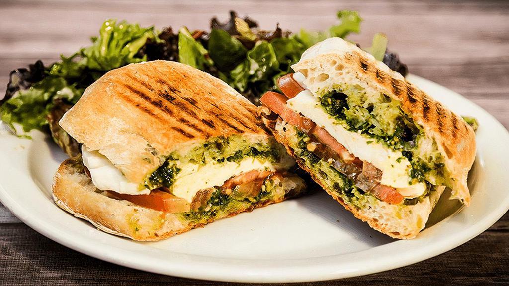 Capresa Panini · mozzarella cheese, tomato, arugula, nut-free pesto, garlic aioli, side of mixed green salad. 🅥=Vegetarian