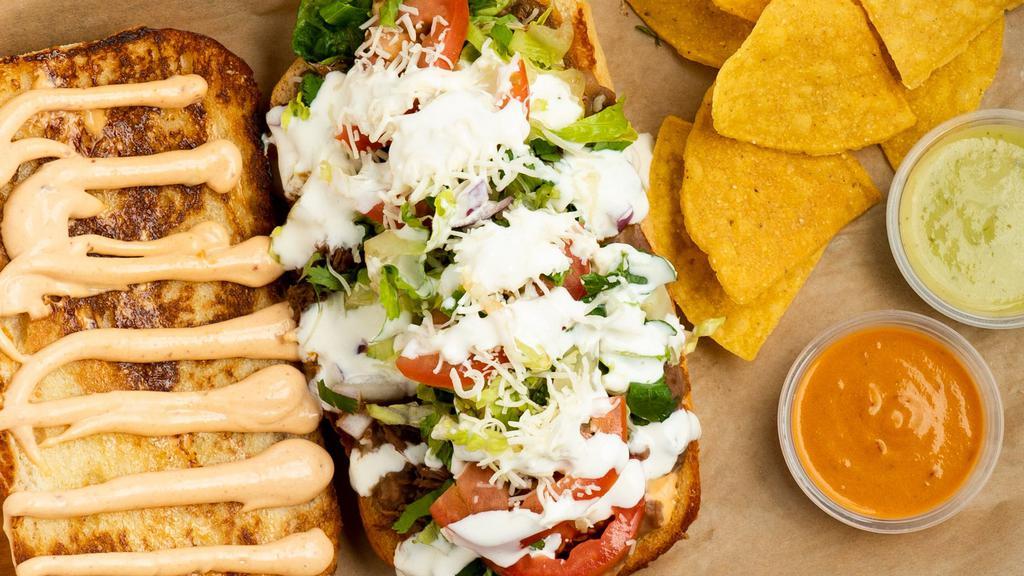 Dutch Crunch Torta · Your choice of meat, chipotle mayo, beans, cheese, lettuce, onion, tomato, cilatnro, salsa verde, and sour cream.