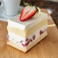 Strawberry shortcake · Vanilla sponge cake with fresh strawberries and whipped cream filling and icing.