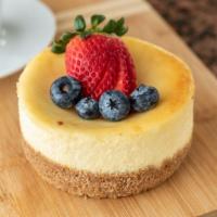 Fruit Cheesecake · Graham crust and rich New York Cheesecake topped with fresh fruit. Fruit may vary depending ...