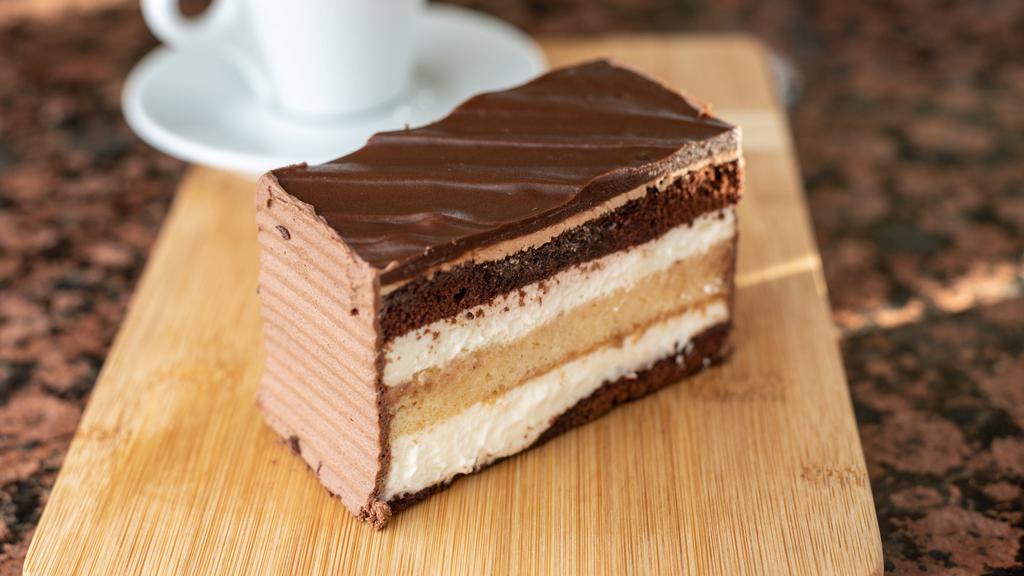 Black and White · Vanilla and chocolate layers alternating with fresh whipped cream and topped with a rich fudge icing.