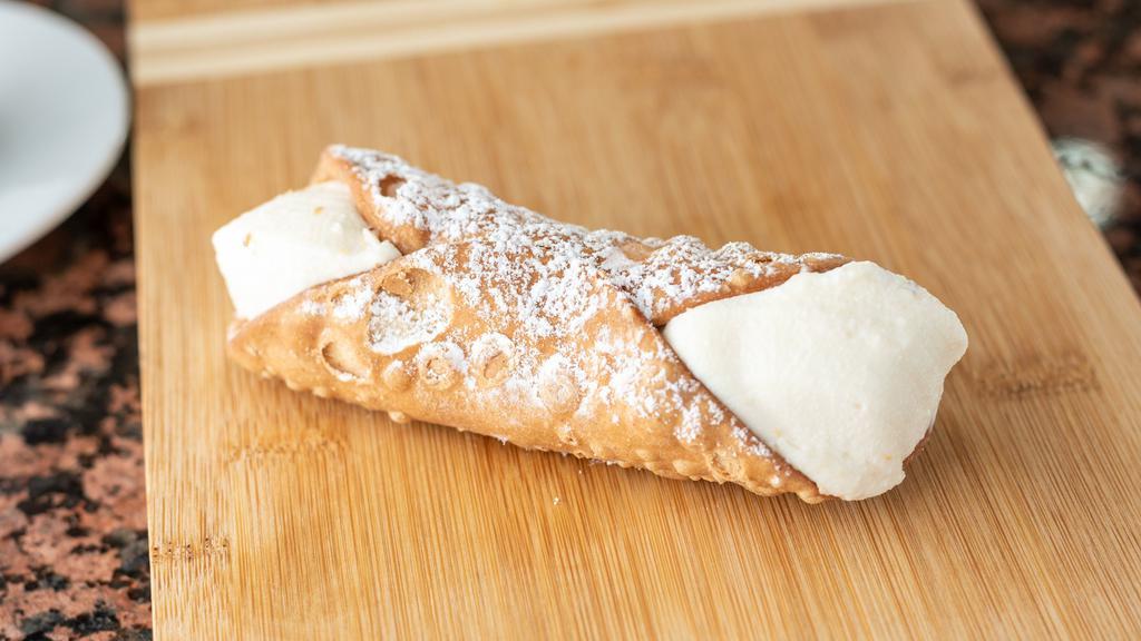 Cannoli · A crisp cannoli shell filled with a slightly sweetened and creamy ricotta filling and sprinkled with chocolate chips.