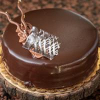 Chocolate Truffle (8” round) · Chocolate devils food cake filled with a decadent ganache filling and topped with a truffle ...