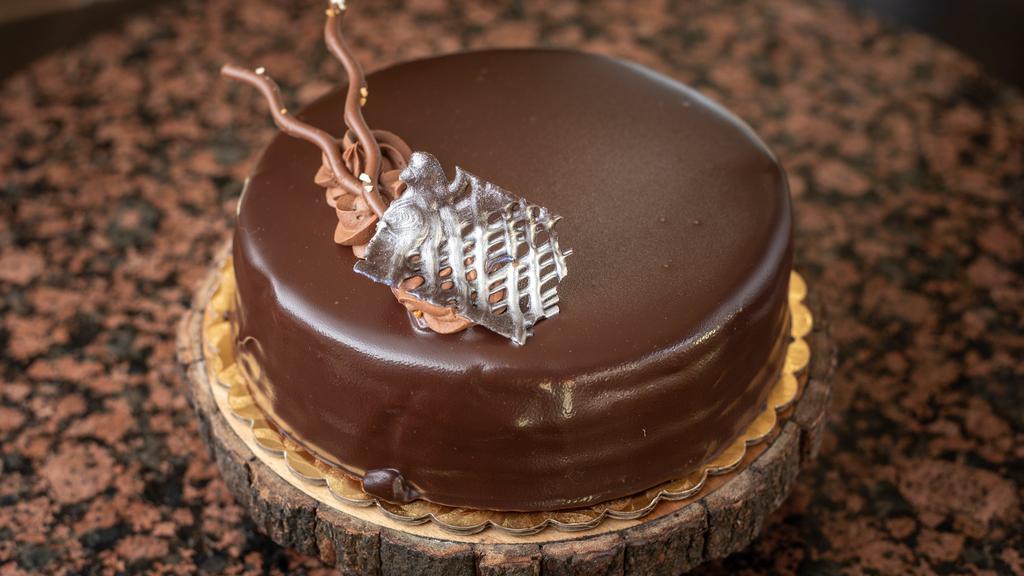 Chocolate Truffle (8” round) · Chocolate devils food cake filled with a decadent ganache filling and topped with a truffle glaze.