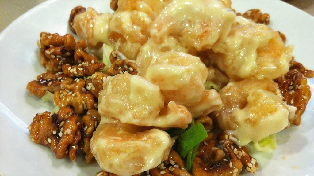 Walnut Prawns · Prawns crisp-sautéed in a tangy white cream sauce and topped with honeyed walnuts.
