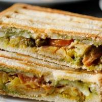 Crushed Samosa Sandwich With Fries · Filled with samosa, finely sliced tomato, Onion, Bell pepper, cilantro chutney. Served grill...