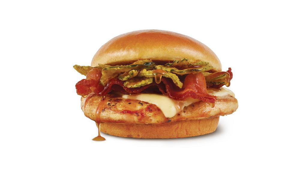 Hot Honey Chicken Sandwich (Grilled) · Herb-marinated grilled chicken breast topped with pepper jack cheese, Applewood smoked bacon, crunchy dill chips, and a drizzle of habanero hot honey sauce all on a toasted bun. Not too hot. Not too sweet. Not to be missed..