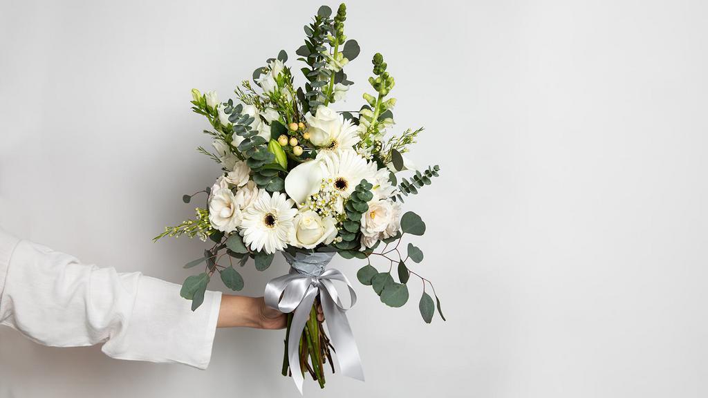 Whispery White Medium Bouquet · Roses, spray roses, snapdragons, gerberas, lilies, mini hydrangeas, callas, fillers and greens.