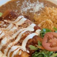 Chicken Enchiladas · 3 chicken enchiladas topped with cheese and paired with rice and beans.