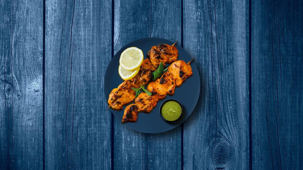Tandoori Chicken Tikka  · Boneless chicken cubes marinated in a traditional tandoori masala and hung yogurt, skewered, and cooked over a charcoal fire in an Indian clay oven.