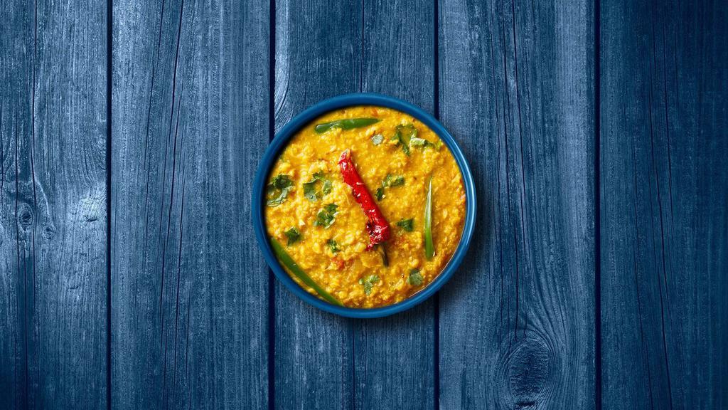 Light Yellow Dal  · Slow-cooked yellow lentils, tempered with tomatoes, onions, green chilis, and Indian spices. Served with a side of aromatic white rice.