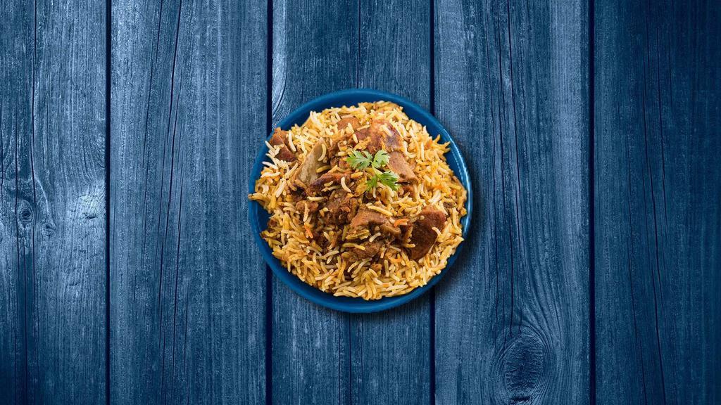 Aromatic Goat Biryani  · Long grain imported 'basmati' rice layered with a curry of bone-in goat meat cooked in our fabulous biryani masala and smoked. Served with a side of yogurt raita and a spicy salan curry.