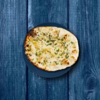 Garlic Naan · A refined flour leavened flatbread, sprinkled with finely chopped garlic and baked in a clay...