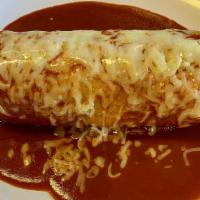Super Burrito Mojado · Super burrito topped with enchilada sauce and cheese.