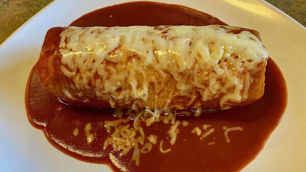 Super Burrito Mojado · Super burrito topped with enchilada sauce and cheese.