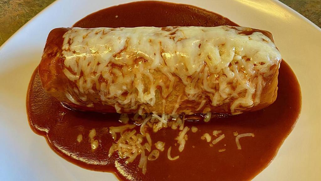 Regular Burrito Mojado · Regular burrito topped with enchilada sauce and cheese.