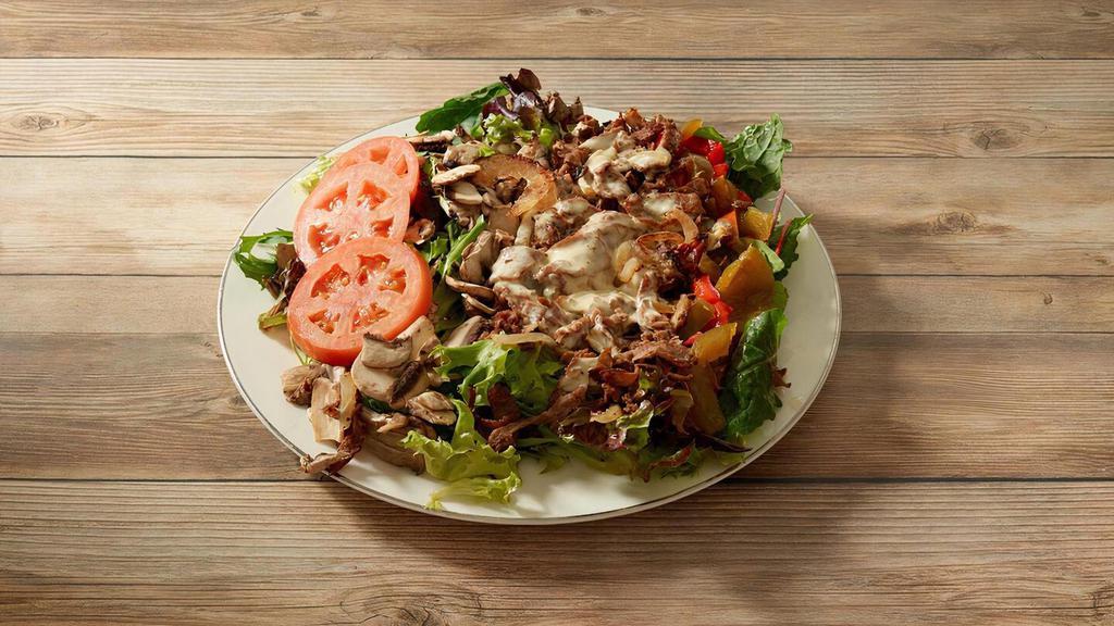Philly Salad · A Generous 7-Ounce Portion of Grilled Steak or Chicken with Melted Cheese, Served on a Bed of Fresh Spring Mix, Mushrooms and Choice of Grilled Onions, Hot and/or Sweet Peppers and Tomatoes. Served with choice of dressing.