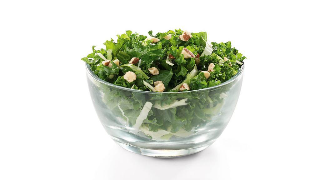 Kale Crunch Side · A blend of Curly Kale and Green Cabbage tossed with an Apple Cider and Dijon Mustard vinaigrette, all topped off with salted, crunchy Roasted Almonds
