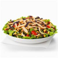 Spicy Southwest Salad · Slices of grilled spicy chicken breast served on a fresh bed of mixed greens, topped with gr...