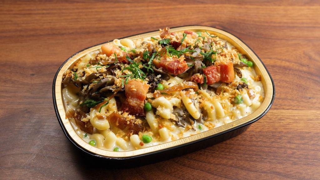Parisian Truffle Mac · Inside you will find mushrooms, bacon, caramelized onions, and black truffle. Topped with garlic streusel and parsley. Contains gluten and dairy. We cannot make substitutions.