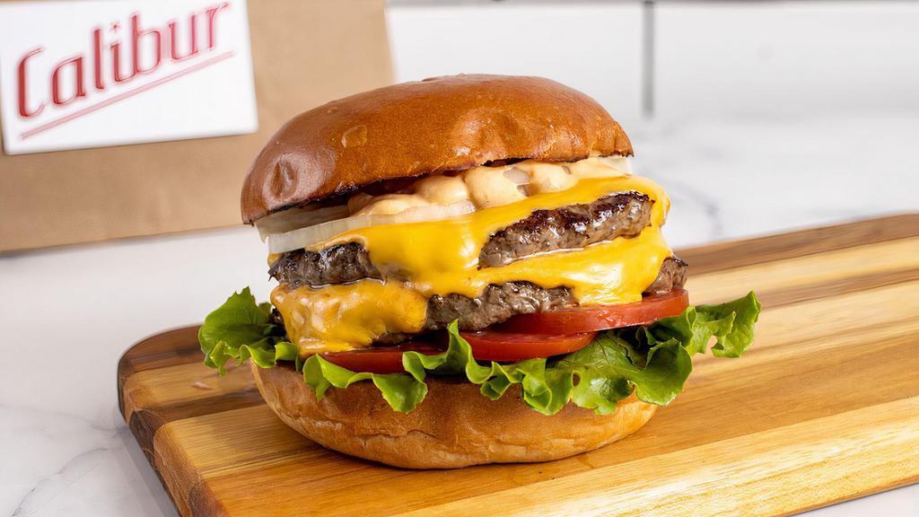 Double Cheeseburger by Calibur Express · By Calibur Express. 1/2 lb fresh, organic, grass fed California beef with double American cheese. Served with lettuce, tomato, yellow onion, and Calibur sauce on the side. Contains gluten, dairy, soy, nightshades, and eggs. We cannot make substitutions.