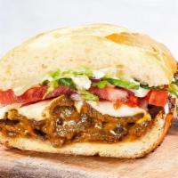 Peruvian Steak Sandwich · Spicy aji amarillo marinated steak with Oaxacan cheese, herb aioli, red onions, tomatoes, sh...