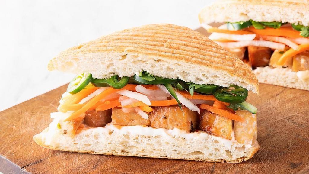Vegan Banh Mi · Organic marinated, baked tofu with vegan aioli, sweet chili sauce, pickled daikon & carrots, cucumbers, jalapenos, Thai basil, cilantro (390 cal) on panini-pressed ciabatta (260 cal). Please note: gluten-free bread is NOT vegan