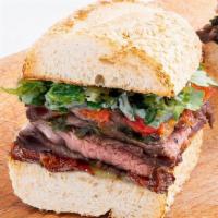 Chimichurri Steak & Bacon · roasted, carved steak and Applewood smoked bacon topped with marinated red peppers, carameli...