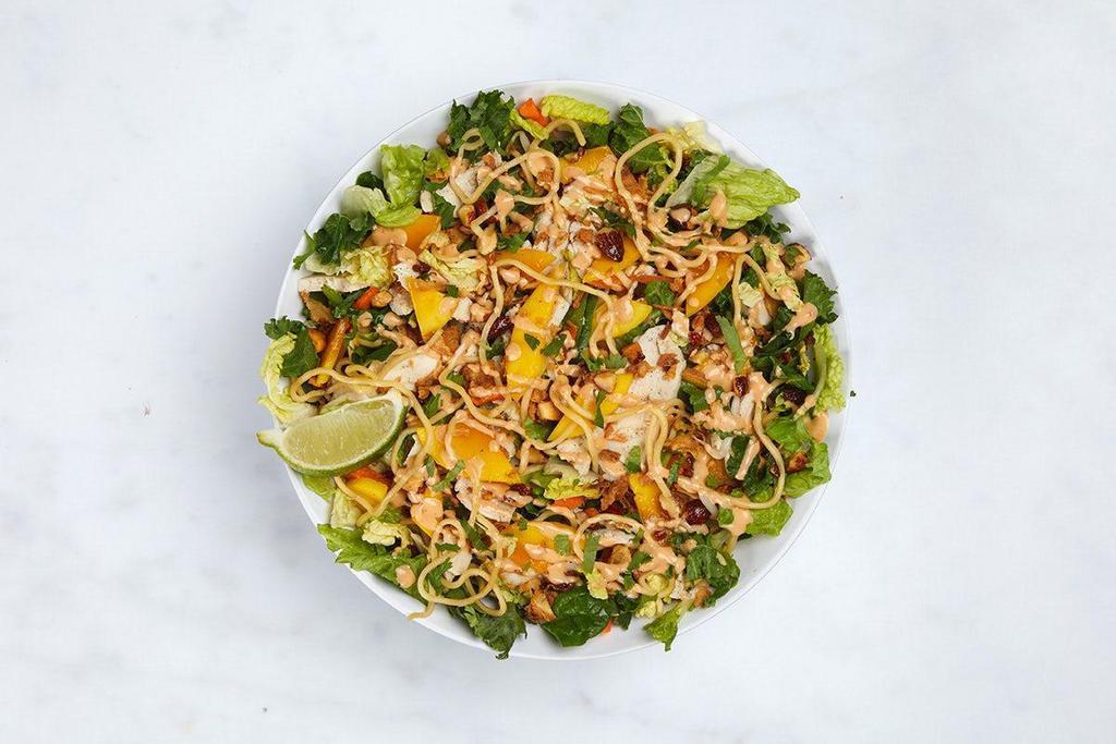 Thai Mango Salad · Shaved, roasted chicken breast, ramen noodles, napa cabbage & kale slaw, sliced mango, honey roasted almonds, pickled daikon & carrots, Thai basil, mint, cilantro, lime, and fried shallots (640 cal) with Thai almond dressing (200 cal)
