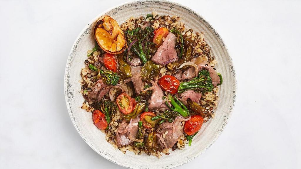 Chimichurri Steak & Shishito Bowl · Roasted, carved steak over ancient grains tossed with caramelized onion jam & chimichurri, baby spinach, roasted shishito peppers with broccolini, tomatoes & red onions, grilled lemon (740 cal)