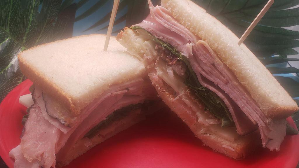 The Manheimer · Black Forest Ham, bacon, swiss cheese, herbed mayo, honey mustard, tomato, spinach and onion on sliced sourdough.