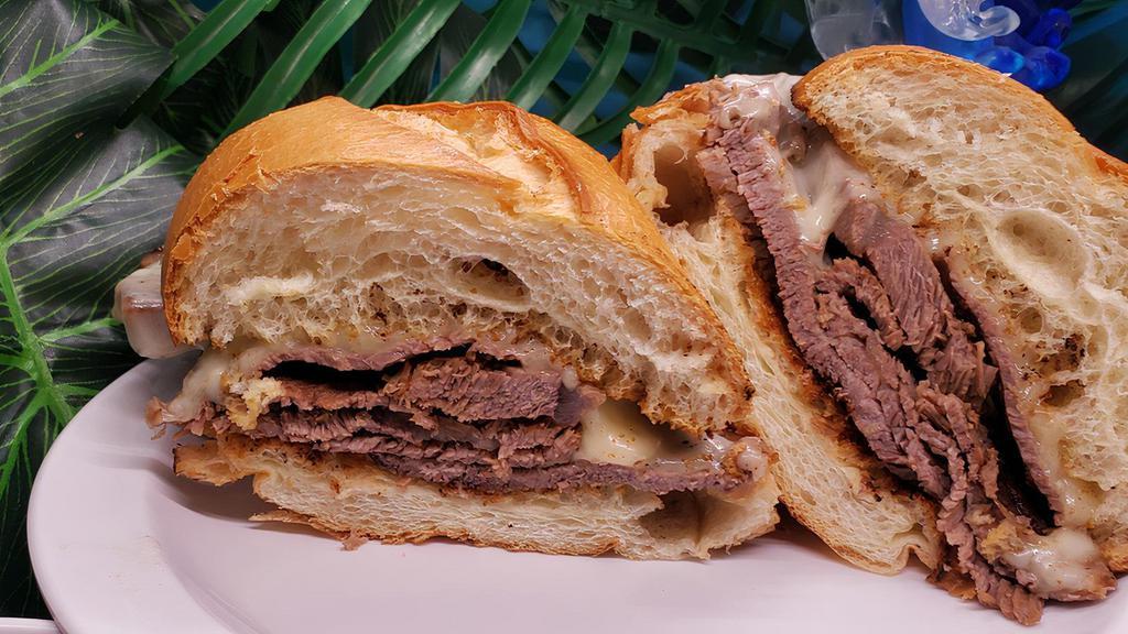 French Dip · Roast beef, provolone on a toasted soft French roll and warm au jus on the side for dipping.