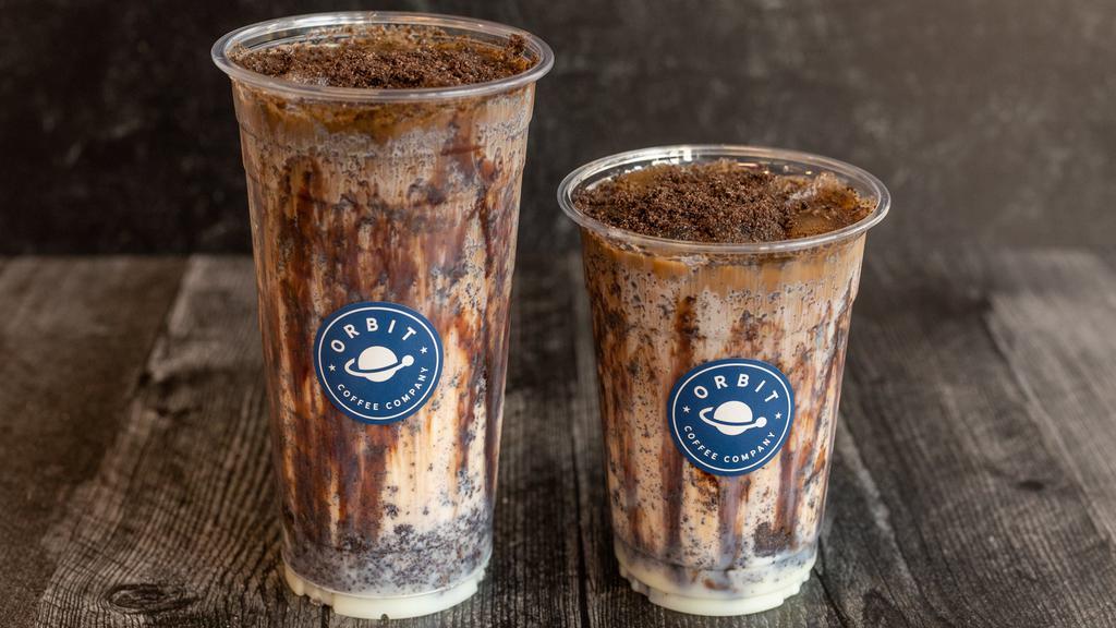 Dark Matter · Orbit coffee espresso, Oreo cookie crumbs, sweetened condensed milk, vanilla, rich dark chocolate drizzle and whole milk, served on the rocks!