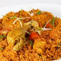 Chicken Biryani · Fresh marinated chicken cooked in spices and basmati rice. Served with fresh raita.