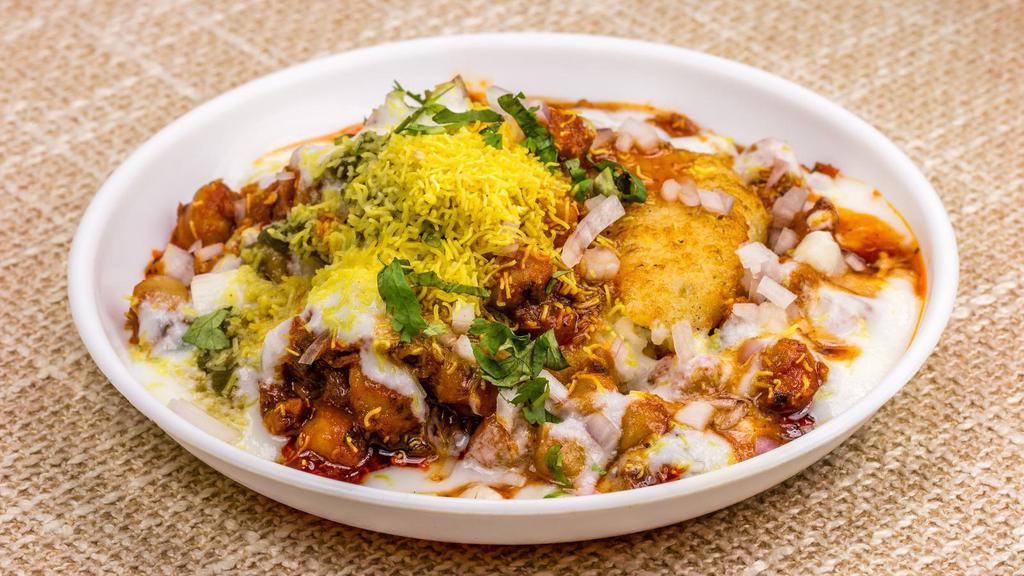 Aloo Tikki Chaat · Fresh fried mashed potatoes with peas, cheese and a bed of garbanzo beans.