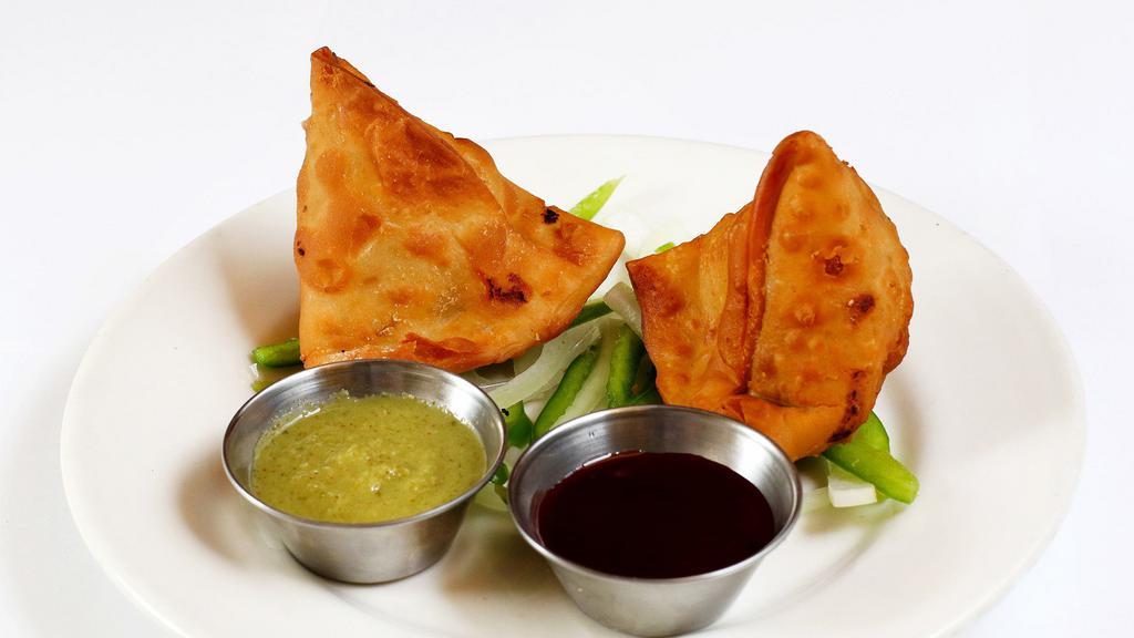 Samosa · 2 pieces of deep fried indian pastries filled with potatoes and peas.