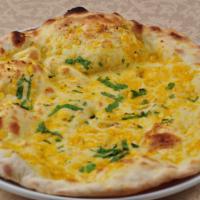 Garlic Naan · Cooked in clay oven and topped with cilantro and garlic.