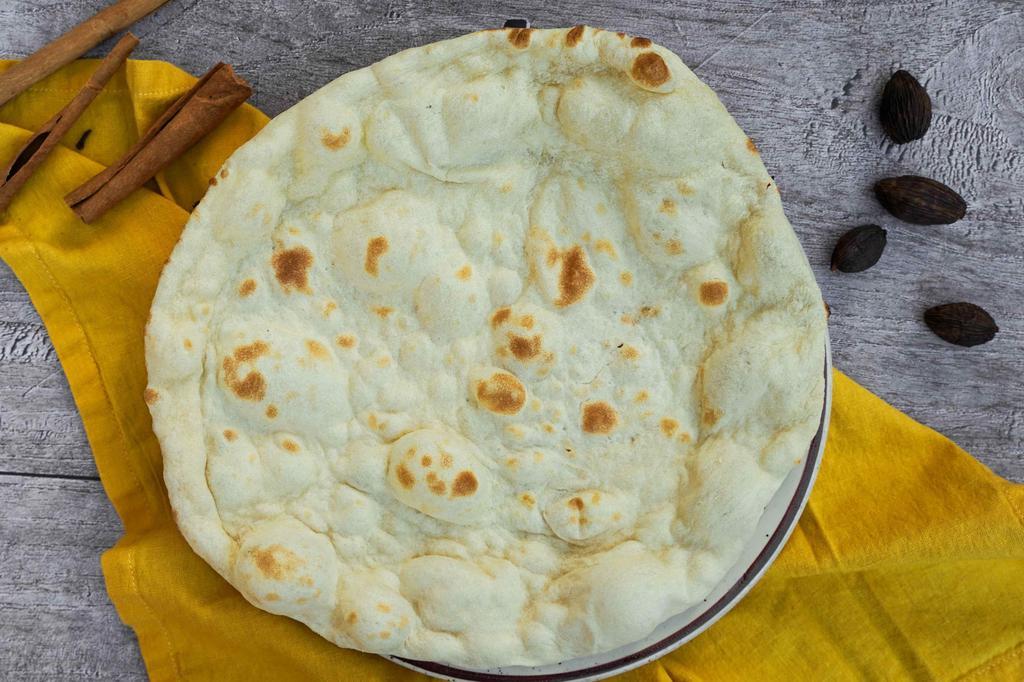 Naan · Cooked in clay oven.