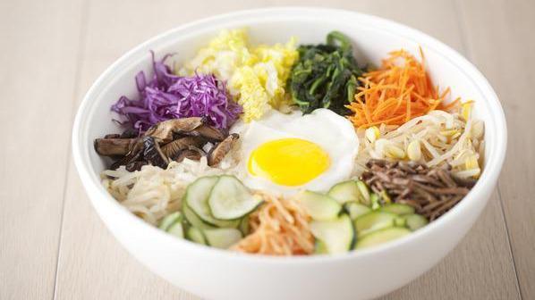 The Works · Ten different kinds of vegetables including carrots, spinach, bean sprouts cucumbers, zucchini, radish and purple cabbage. Served over rice with choice of protein, sesame oil, an egg sunny-side up, and Korean spicy chili paste on the side.