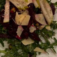 Rocola · Baby arugula with marinated beets, pear, pistachio, and shaved parmesan in a chamagne vinaig...
