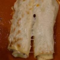 Cannelloni · Homemade crepes filled with milk fed veal, spinach, ricotta cheese in a creamy tomato sauce