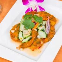 Fried Fish Cake · Thai style fried fish cake served with cucumber salad.