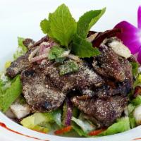 Beef Salad (Nam Tok) · Beef with mint leaves, cilantro, onions, toasted rice powder in spicy lime dressing.