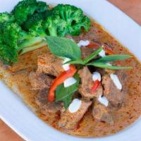 Panang Beef Curry · Chunks of tender beef with panang curry paste, coconut milk, and Thai basil, served with bro...