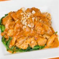 Pad Praram · With peanut curry sauce with coconut milk, served on spinach.