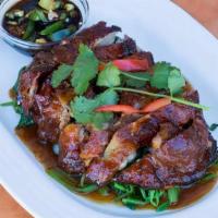 Roasted Duck · Roasted boneless duck on a bed of spinach with homemade special sauce.