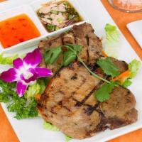 BBQ Pork · Broiled marinated pork chop with fresh herbs and spices served with spicy tamarind sauce.