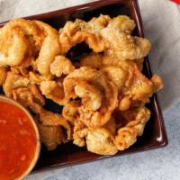 Cluckins · Fried chicken skins served with sweet and sour sauce