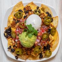 Nachos Supreme (GF/NF) · Fried corn tortilla chips or french fries, served with cheese sauce, beans, sour cream, pico...